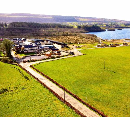 an aerial view of a building with a field and water at Dulrush Self-Catering Lodges in Belleek