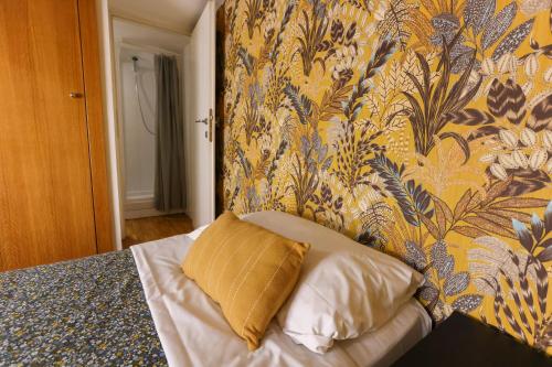 a bedroom with a bed with a yellow wall at casa dolce casa in Rome