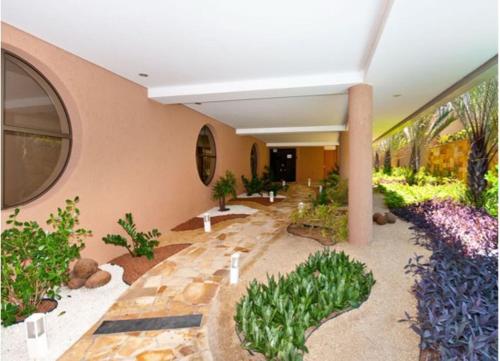 a lobby with flowers and plants in a building at Mirador Praia Hotel in Natal