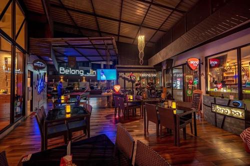 a restaurant with tables and chairs and a bar at Homey At The Dam, Private House in Ban Ta Khun