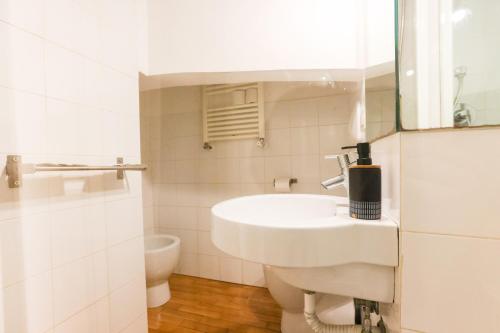 a white bathroom with a sink and a mirror at casa dolce casa in Rome
