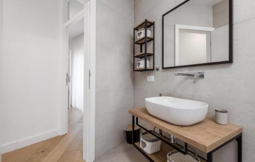 a bathroom with a white sink and a mirror at Charming Holiday Home with private heated pool in Jakišnica