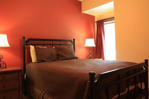 a bedroom with a bed with red walls and a window at Cliff Davidson in Sampson