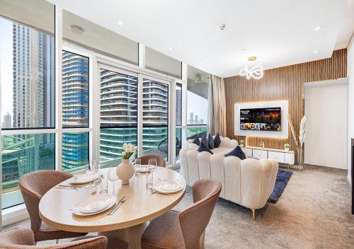 a living room with a table and chairs at Nice 2 Bedroom Apartment! 5 Minute walk to Dubai Mall! Burj Khalifa View! in Dubai