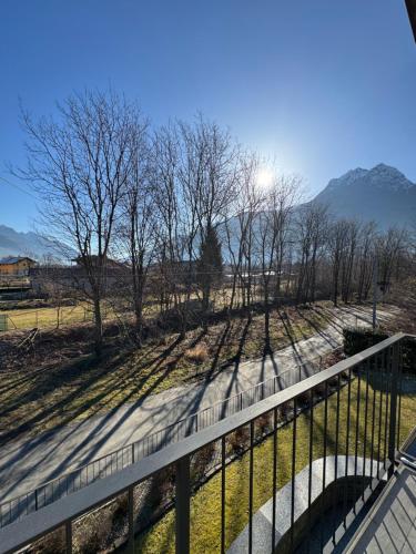 a balcony with a fence and trees and mountains at Casa vacanza Valentina in Vogogna