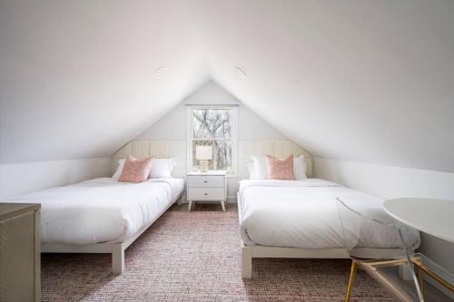 a attic bedroom with two beds and a sink at Marys Gated Oasis Private Estate in Southampton