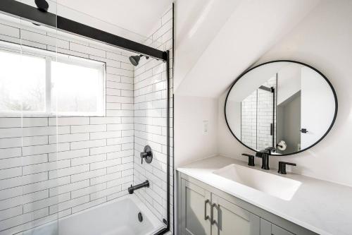 a white bathroom with a sink and a mirror at Marys Gated Oasis Private Estate in Southampton