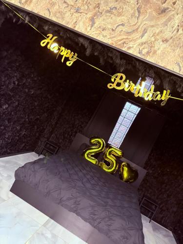 a bed with a happy birthday sign on top of it at Délicate addiction spa in Lens