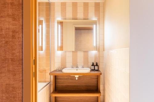 a bathroom with a sink and a mirror at The Ostendian in Ostend