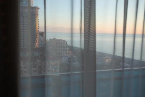 a view of a city skyline from a window at ORBI City N9 HoTeL in Batumi