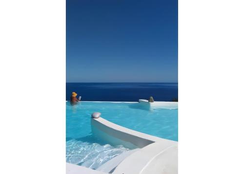 a swimming pool with a slide in the water at Kaladi Rock Ammos in Avlemonas