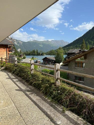 a fence with a view of a lake and mountains at Au Vieux Champex in Champex