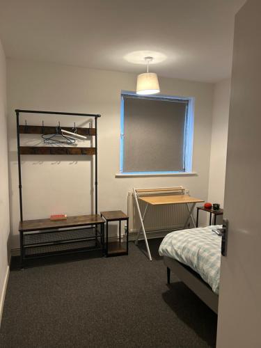 a room with a bedroom with a bed and a window at Newmarket house in Newmarket