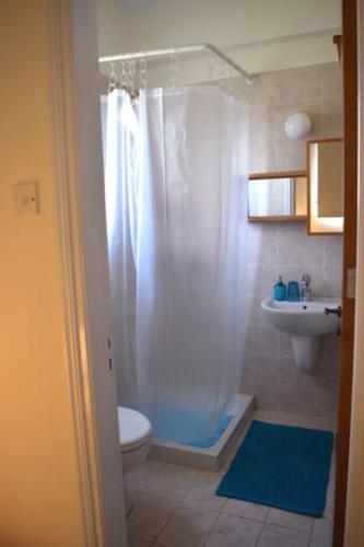 a bathroom with a shower and a toilet and a sink at Villa Calm 100m from the beach in Ayia Napa