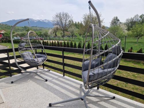 two metal chairs sitting on top of a balcony at New Wolf in Bran