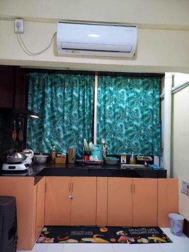 a kitchen with a green curtain over a window at Condo for Rent - Cagayan de Oro in Cagayan de Oro