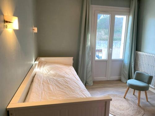 une chambre avec un lit, une chaise et une fenêtre dans l'établissement Appartement 2 chambres avec vue sur mer et parking à Perros-Guirec - FR-1-368-154, à Perros-Guirec