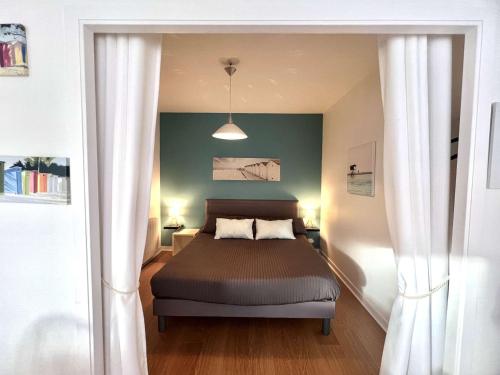 a bedroom with a bed and a green wall at Appartement 3* à Bénodet, terrasse, parking, à 150m de la plage et thalasso - FR-1-481-49 in Bénodet
