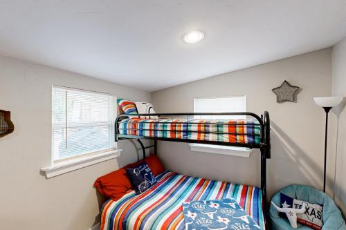 a bedroom with two bunk beds and a window at Texas Rodeo in Kerrville