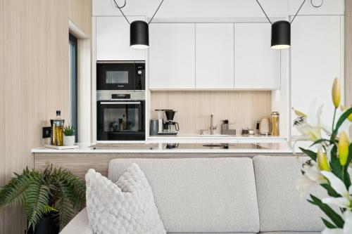 a living room with a couch and a kitchen at High end cabin with Jacuzzi in Lyngværet