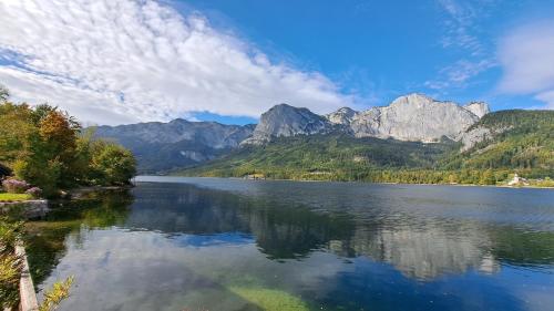 a view of a lake with mountains in the background at Haus Seegarten - LANDLUFT in Grundlsee