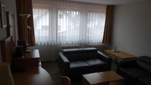 a living room with a couch and a table at Hotel Altenberg in Baden-Baden