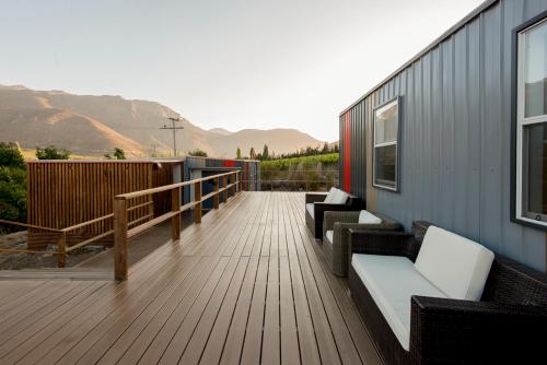 a deck with couches and chairs on a building at Hotel Village Chillepín in Choapa