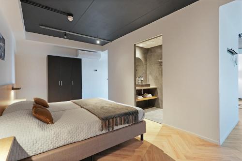 a bedroom with a bed and a walk in closet at Dock Hotel Stellendam in Stellendam