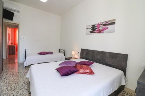 Giường trong phòng chung tại Casa Giorgia a Otranto 8 posti