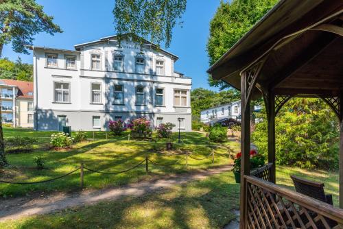 a view of a house from a porch at Ostseehotel Villen im Park - ein Rovell Hotel in Bansin