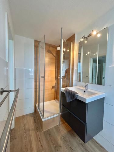 a bathroom with a sink and a shower at Ferienwohnung West in Fehmarn