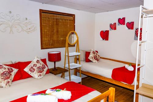 two beds in a room with hearts on the wall at A Cherry Lane Self Catering and B&B in Bloemfontein