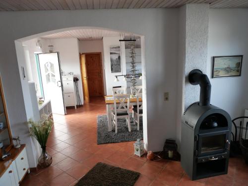 a living room with a wood stove and a table at direkt am Wasser ""Küstenperle"mit Meerblick und Sauna in Hohenkirchen