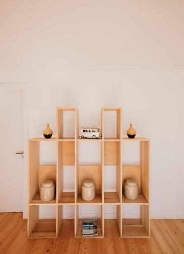 a shelf with vases and a toy car on it at Thyme & Tide Beach Villa in Yzerfontein
