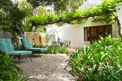 a patio with two chairs and a table at Woodall Country House and Spa in Addo