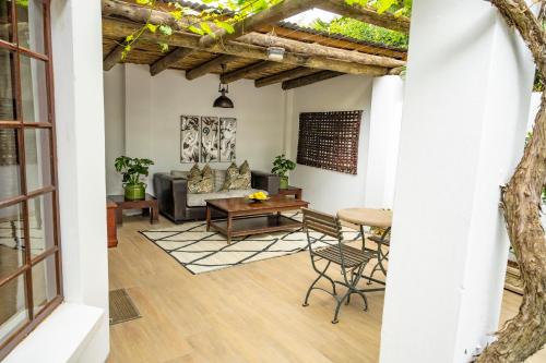 a living room with a couch and a table at Woodall Country House and Spa in Addo
