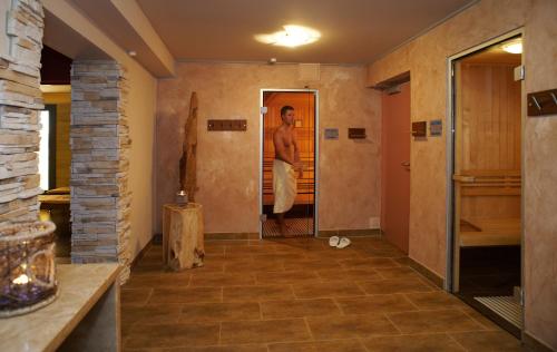 a man standing in the doorway of a bathroom at Ostseehotel Villen im Park - ein Rovell Hotel in Bansin