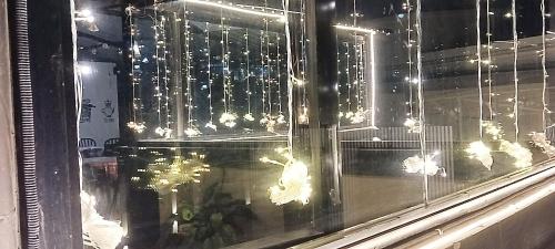 a window with a bunch of butterflies on it at PHIBHA VILLA in Shillong