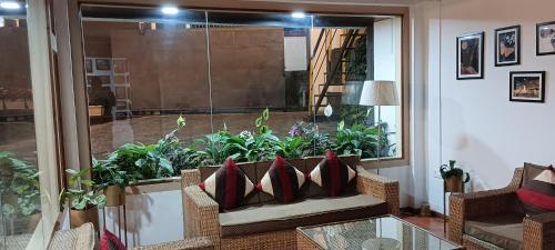 a living room with a couch and some plants at PHIBHA VILLA in Shillong