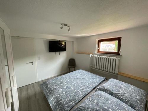 a bedroom with two beds and a flat screen tv at nordnest in Ostseebad Karlshagen