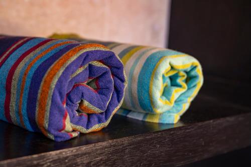 two rolled up towels sitting on top of a table at Woodall Country House and Spa in Addo