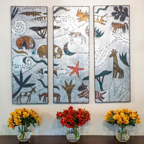 four paintings on a wall with flowers in vases at Woodall Country House and Spa in Addo