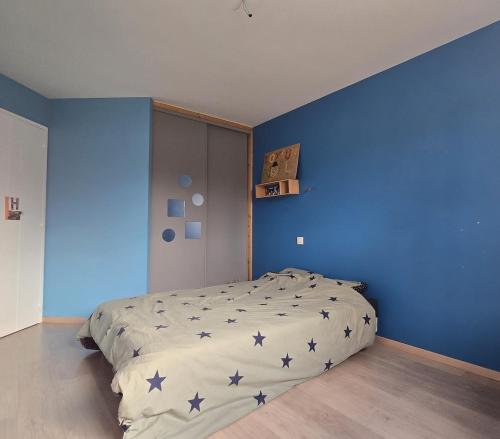 a blue bedroom with a bed with stars on it at la belle de volnay in Volnay