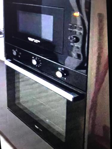 a microwave oven sitting inside of a stove at DEJ APARTMENTs BY LAND MARK in Lekki