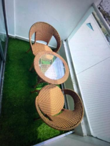 two wicker chairs sitting on top of a balcony at DEJ APARTMENTs BY LAND MARK in Lekki