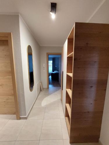 a hallway with wooden shelves in a house at Komfort Appartements serviced by Auhof in Kaprun