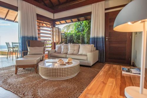 a living room with a couch and a table at Pousada Morena in Fernando de Noronha