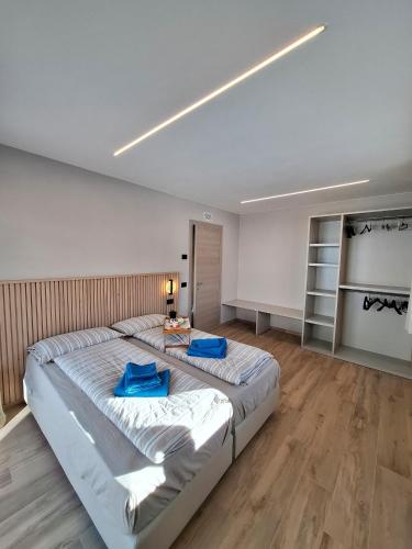 a bedroom with a large bed with blue pillows on it at Appartamento Sbuffo Livigno in Livigno