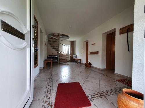 a living room with a red rug on the floor at Landhaus Oberlausitz in Malschwitz