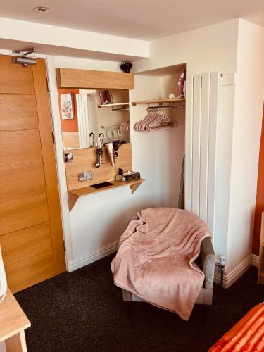 a bedroom with a bed and a closet with shelves at The Beaucliffe Hotel in Blackpool